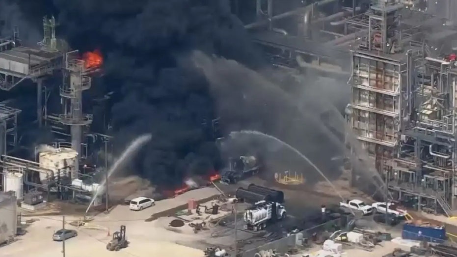 Firefighters throwing water on Deer Park fire