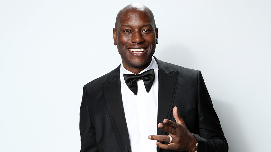 Tyrese poses for portrait in black suit and bow tie