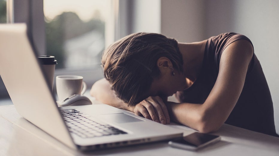 employee at desk, stressed