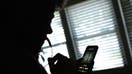 This illustration image created on June 9, 2023, shows a person using a smartphone to record a voice message in Los Angeles. The biggest peril of Artificial Intelligence, experts say, is its ability to blur the boundaries between reality and fiction, handing cybercriminals a cheap and effective technology to exploit. In a new breed of scams that has rattled US authorities, fraudsters are using strikingly convincing AI voice cloning tools -- widely and cheaply available online -- to steal from people by impersonating family members.