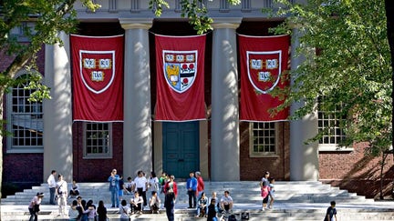 Harvard banners hang outside Memorial Church on the Harvard University campus in Cambridge, Massachusetts, on Friday, Sept. 4, 2009. 