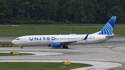 A United Airlines plane is seen taxiing on the tarmac at Orlando International Airport in Orlando.  - Fox Business News