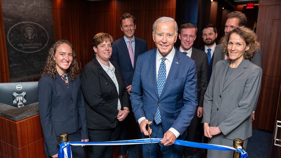 Biden cutting a ribbon