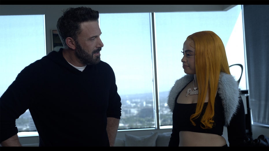 Ben Affleck and Ice Spice greet each other in Dunkin's Ice Spice MUNCHKINS Drink commercial.