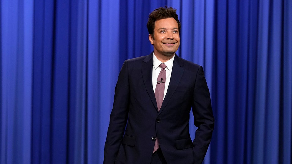 Jimmy Fallon standing on The Tonight Show set