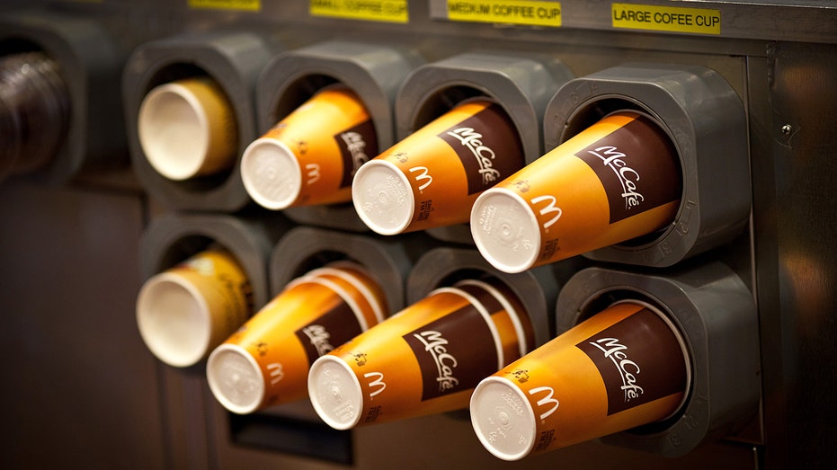 McDonald's McCafe coffee cups in a restaurant dispenser.