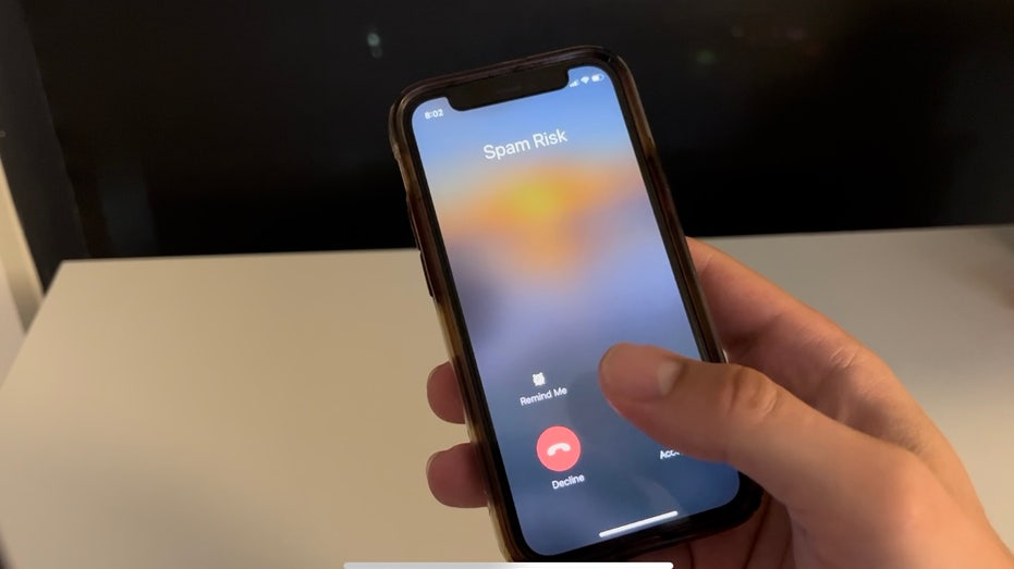 Person hovering over decline button on phone