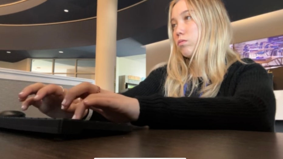 Woman sitting at the computer typing