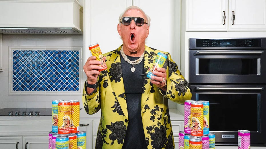 Ric Flair poses with Wooooo! Energy drink