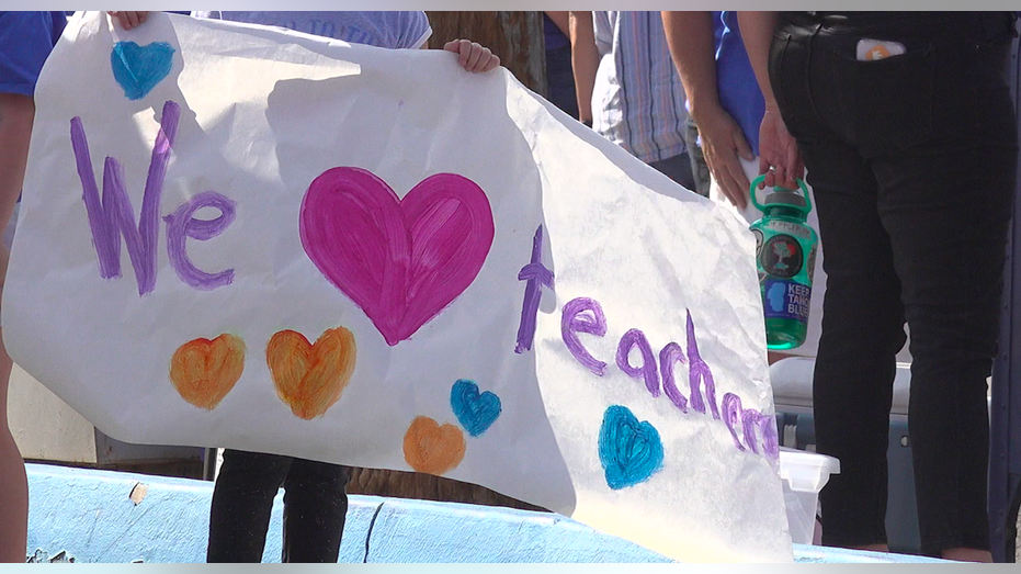 A poster states 'we love teachers.'