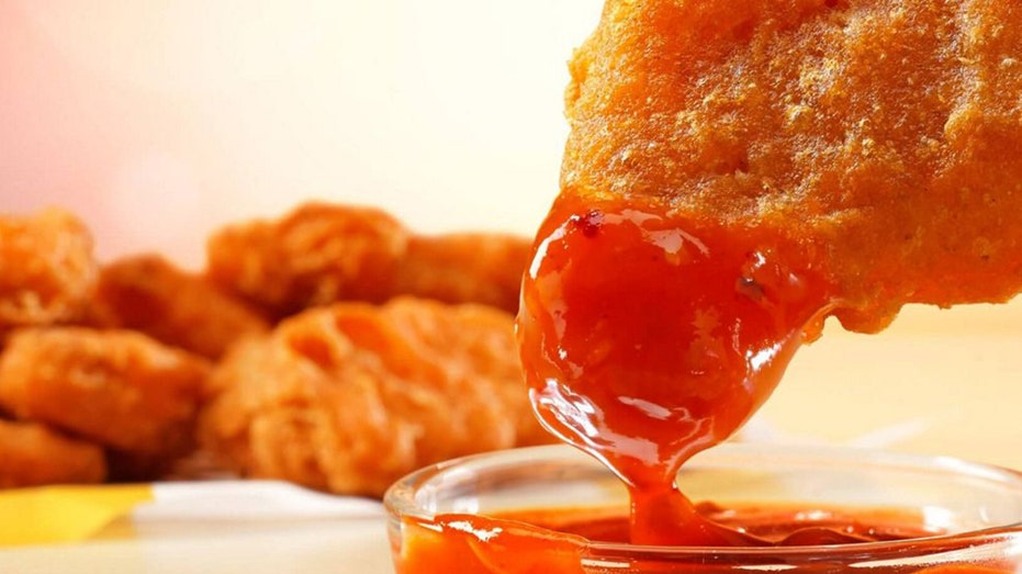 Spicy Chicken McNuggets being dipped into sauce