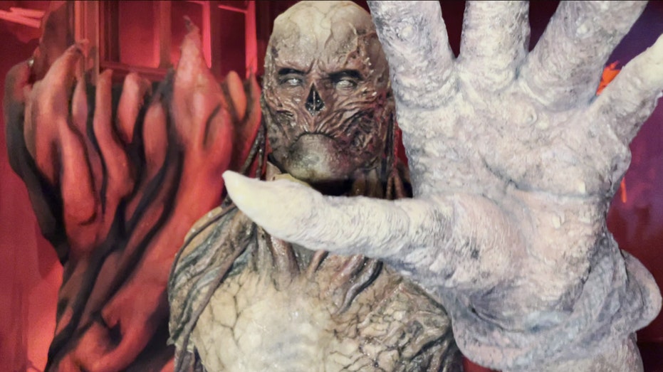 'Stranger Things' season four villain Vecna holds up a clawed hand at the 'Stranger Things 4' haunted house.