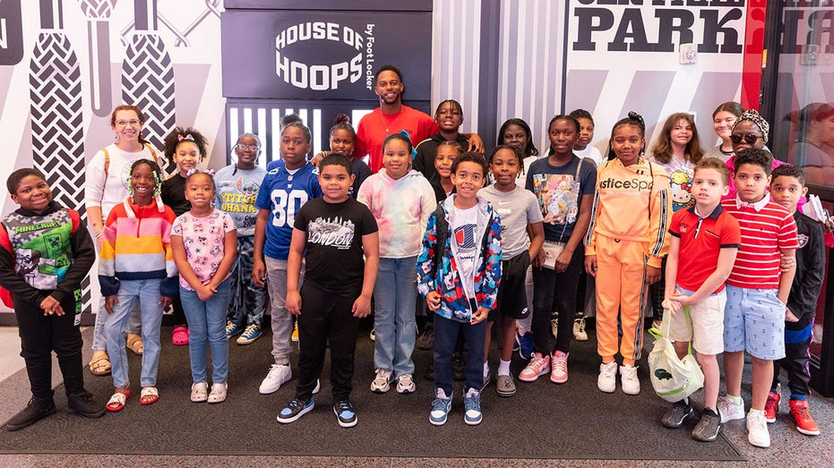 Victor Cruz poses with kids at Foot Locker