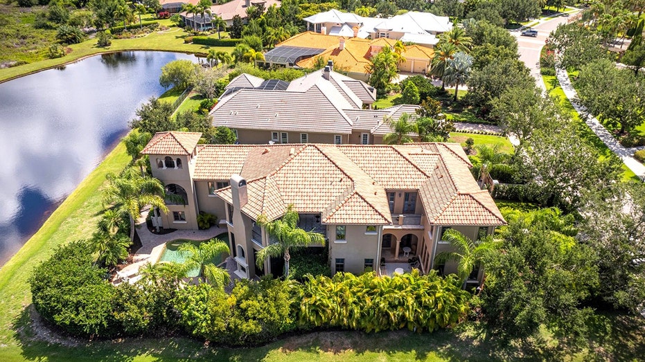 aerial view of house next to the water