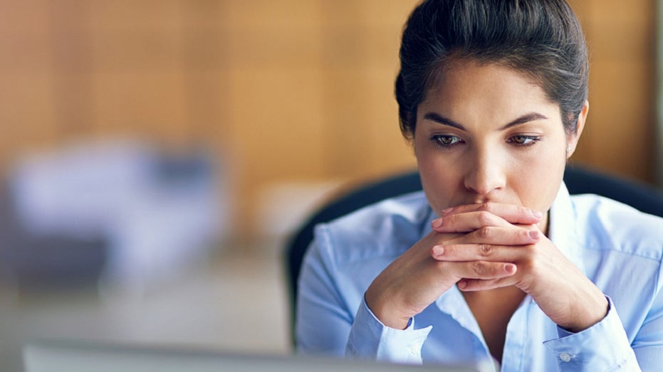 female worker discouraged in front of computer