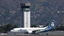 BURBANK, CALIFORNIA - SEPTEMBER 25: The control tower at Hollywood Burbank Airport stands over an Alaska Airlines plane as it taxis on September 25, 2023 in Burbank, California. Transportation Secretary Pete Buttigieg is warning that vital training for new air traffic controllers would be paused if the government shuts down later this week. The Department of Transportation currently has 2,600 much needed air traffic controllers undergoing training and employs 1,200 fewer certified controllers than that agency did 10 years ago. 