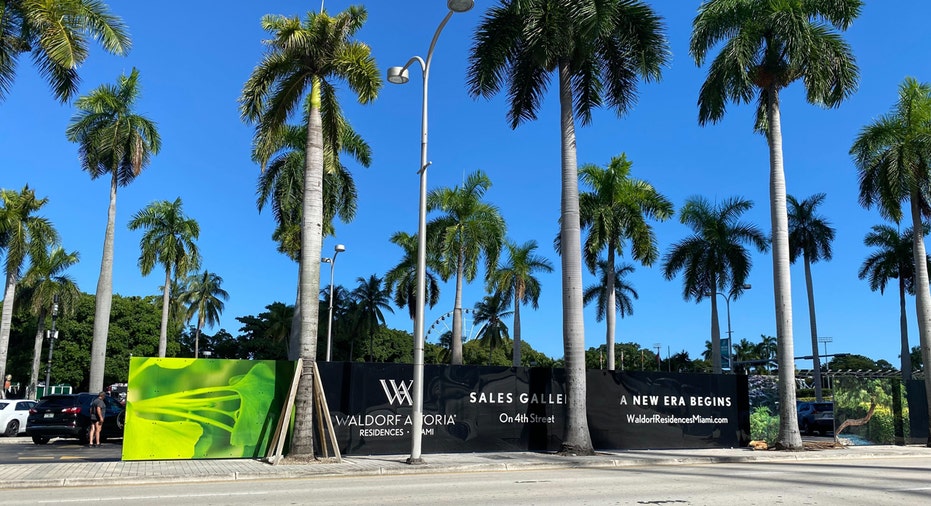 Waldorf Astoria Residences Miami sales gallery sign in front of the construction site.