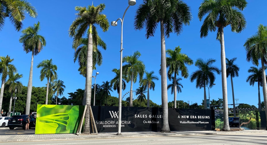 Waldorf Astoria Residences Miami sales gallery sign in front of the construction site.