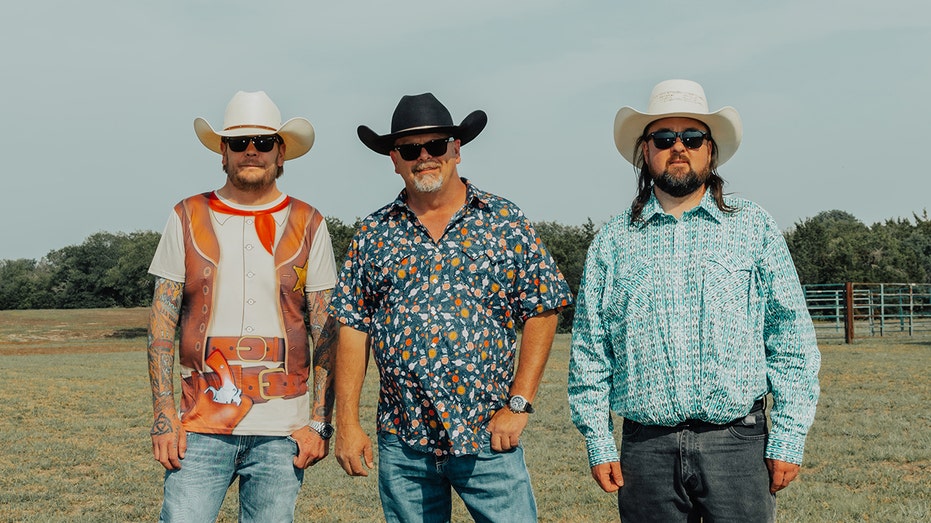 Corey Harrison, Rick Harrison and Chumlee all wearing printed shirts, blue jeans and cowboy hats