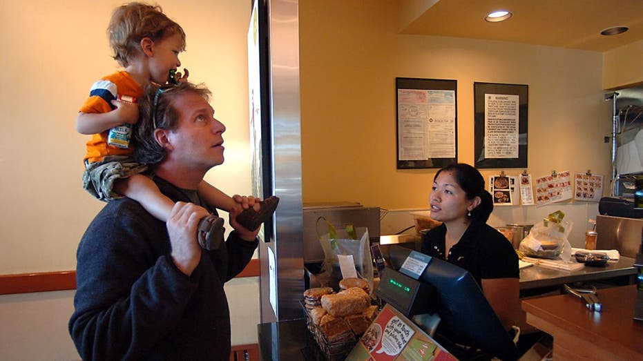 Noodles & Company employee taking father and son's order