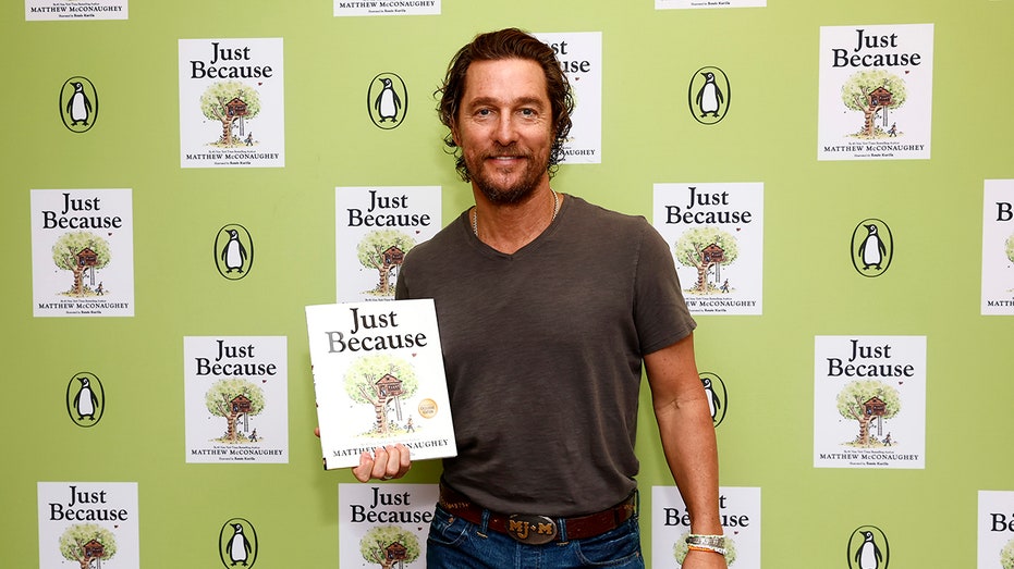 Matthew McConaughey posing with his children's book