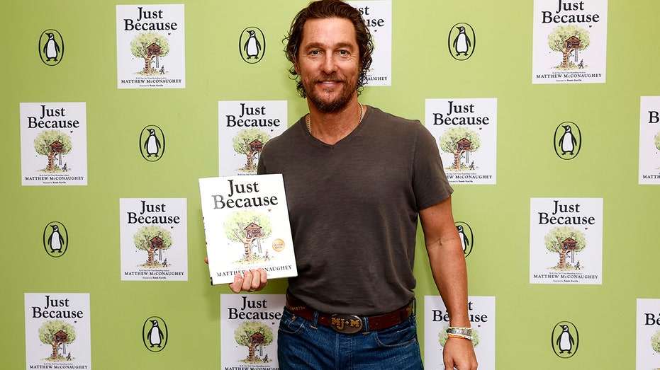 Matthew McConaughey posing with his children's book