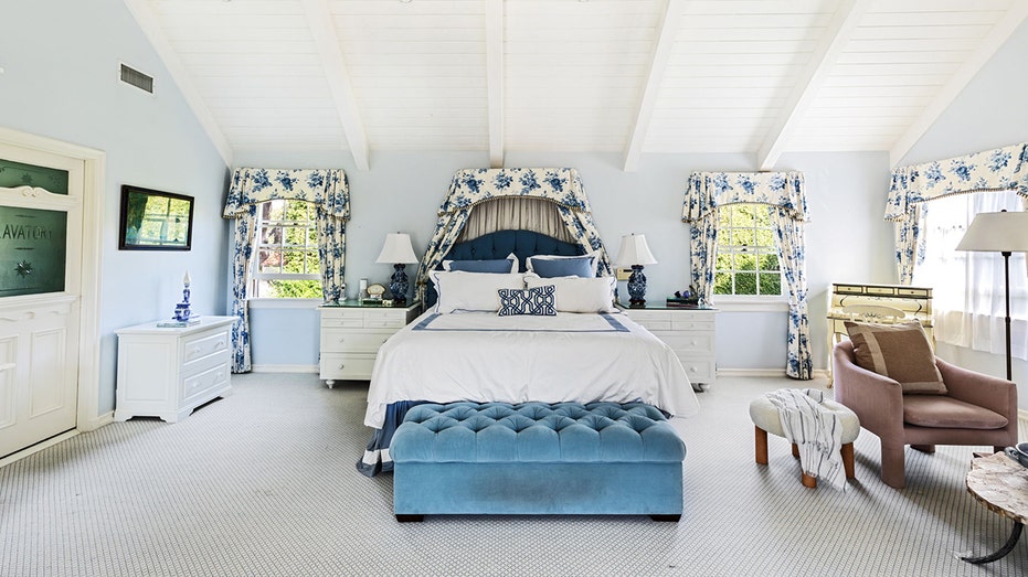 A white bedroom with blue accents