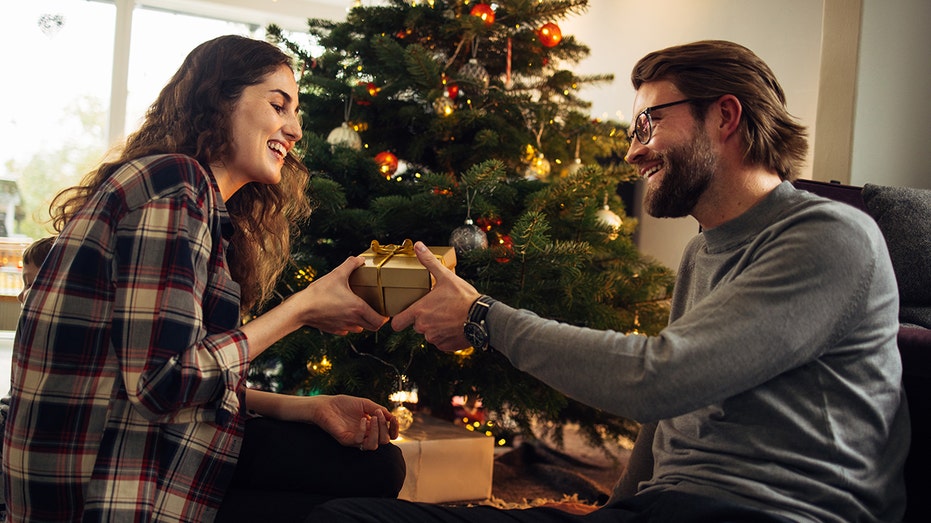 Couple exchanging Christmas gifts