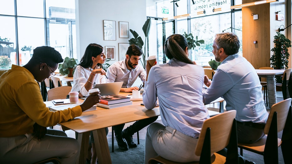 group of business people sitting at table