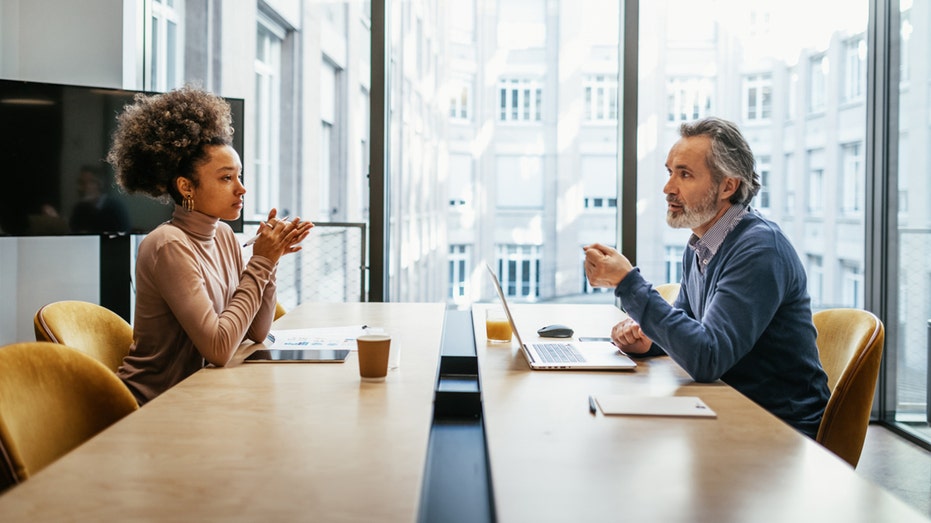 business people sitting across from one another