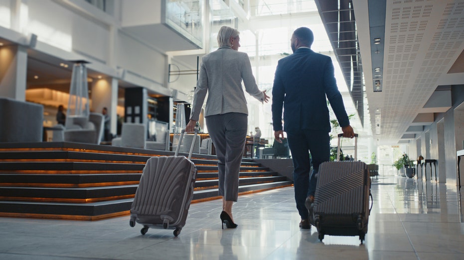 business people walking through airport