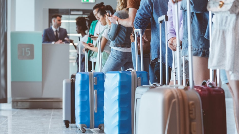 people waiting to board plane