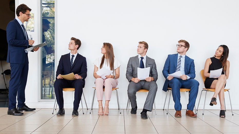 job candidates sitting on wall