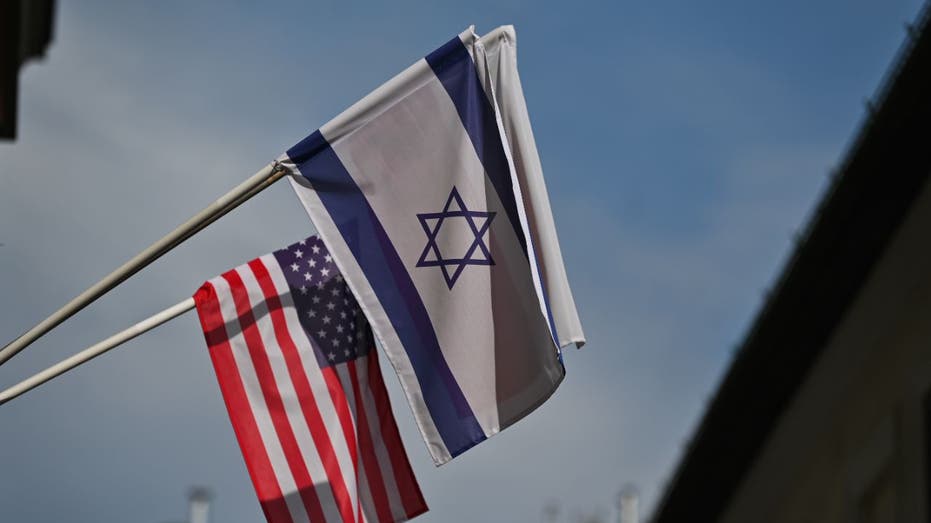 Israeli flag with U.S. flag behing it