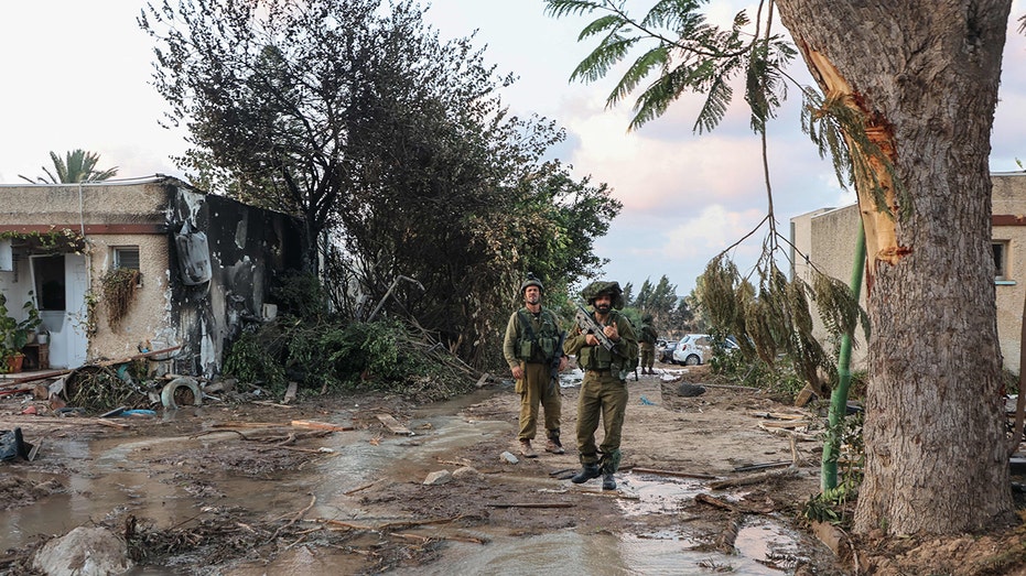 Israeli troops investigate the scene of a Palestinian militant attack