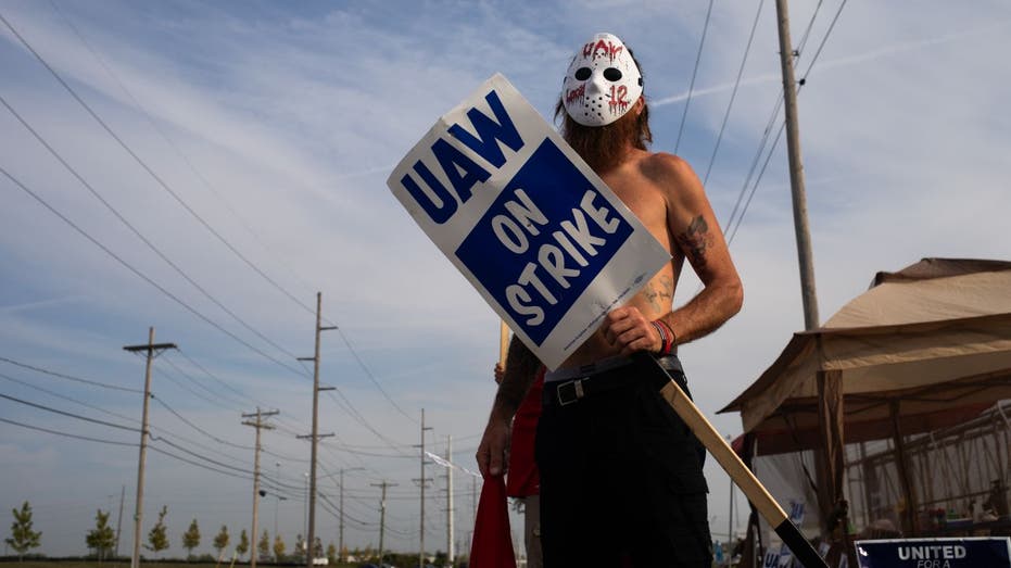 Striking UAW worker wearing halloween mask