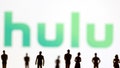 Silhouettes of toy figures are photographed in front of the Hulu logo in a January 20, 2022 illustration.