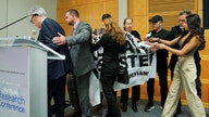 Fed Chair Powell rushed off stage after climate protesters interrupt speech