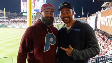 Jason and Travis Kelce pose for a photo during Game 1 of the NLCS between the Arizona Diamondbacks and the Philadelphia Phillies at Citizens Bank Park on Monday, October 16, 2023 in Philadelphia, Pennsylvania.
