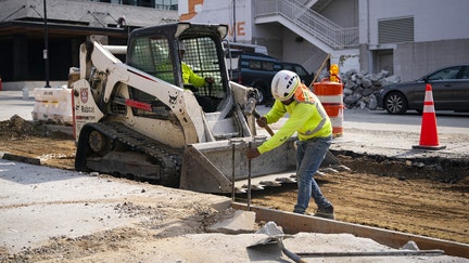 A construction worker hammers a beam while renovating a road in the Union Market district in Washington, DC, US, on Friday, Sept. 8, 2023. US employment gains will slow significantly and be more concentrated across few sectors in the decade through 2032 as population growth moderates, fresh government estimates show.