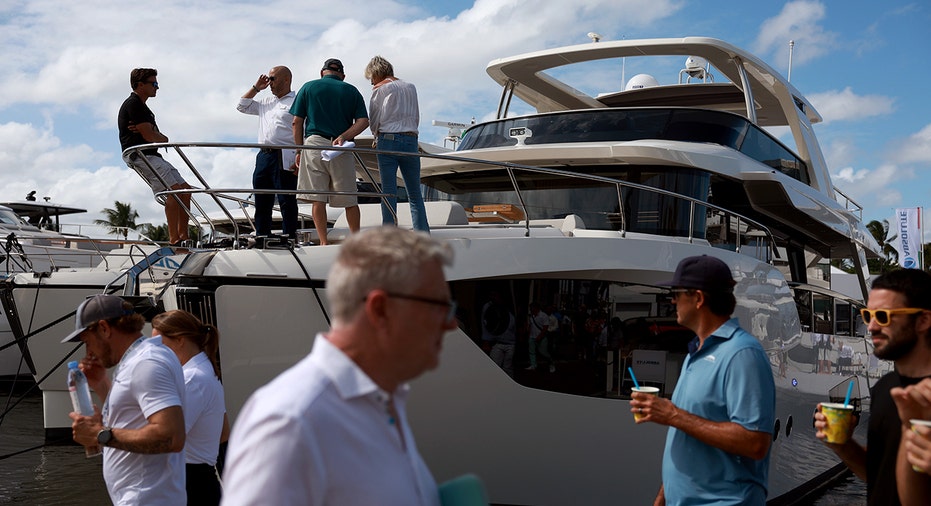 Boat show guests walk around vessels