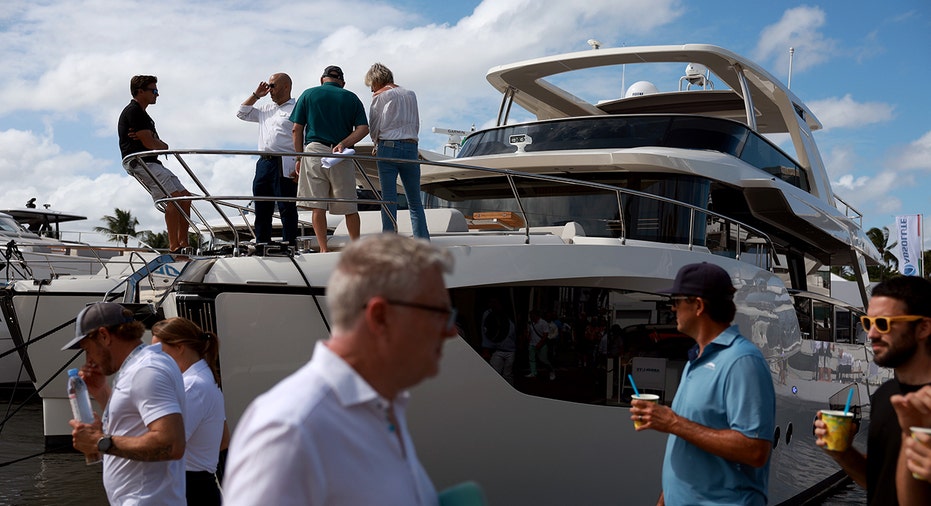 Boat show guests walk around vessels