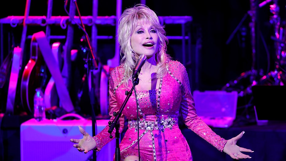 Dolly Parton singing at a microphone