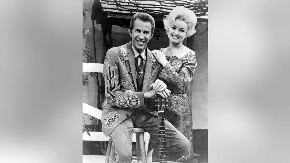 Black and white photo of Porter Wagoner and Dolly Parton