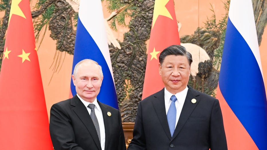 Xi and Putin shake on new deals