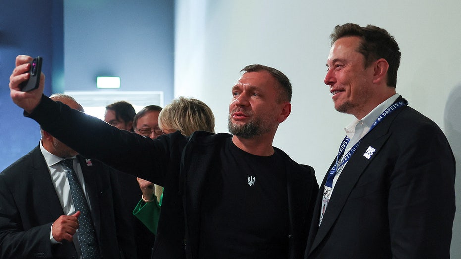 Elon Musk poses for a selfie with a Ukrainian official