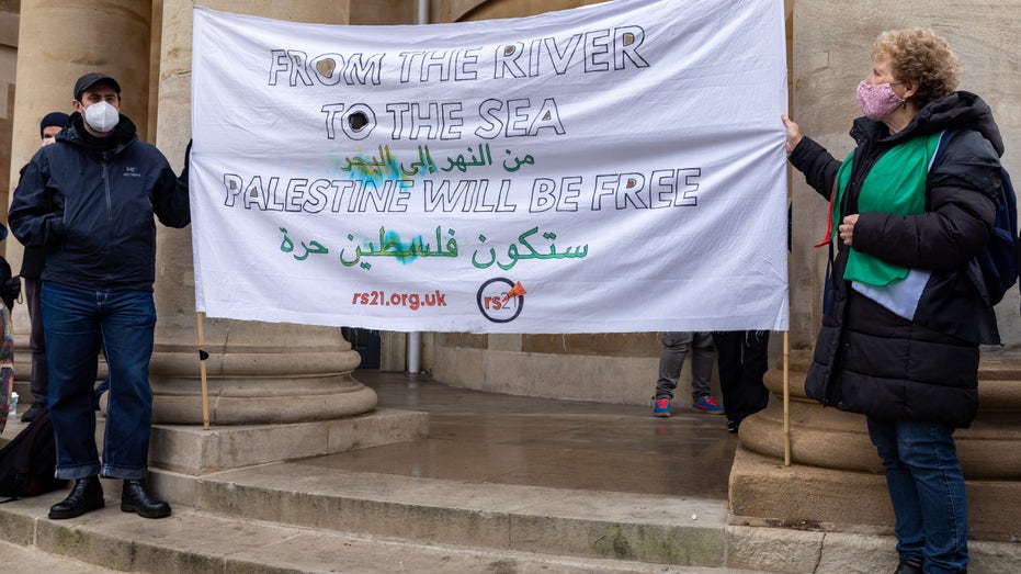 pro-Palestinian demonstrators unfurl sign