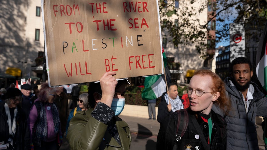 Anti-Israel protest with "from the river to the sea..." sign