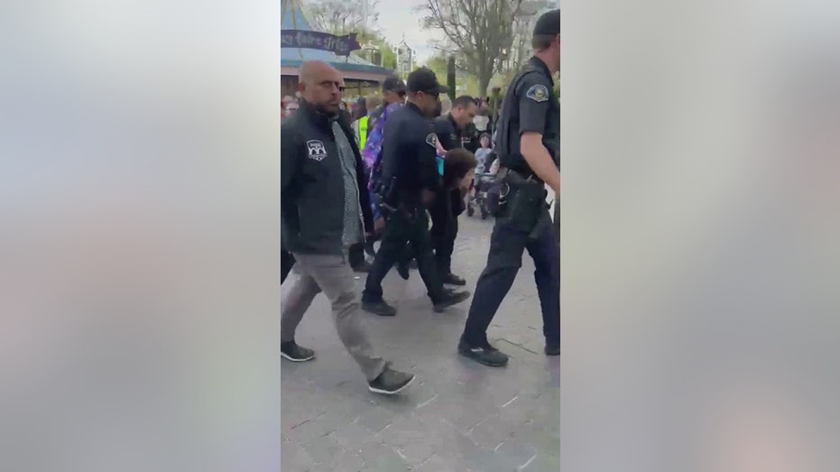 police carrying away naked man
