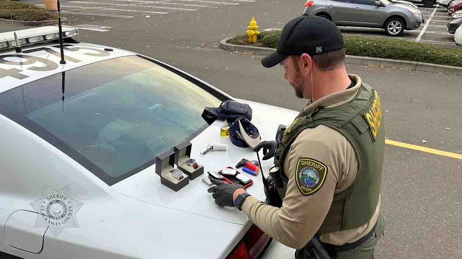 deputy with recovered merchandise